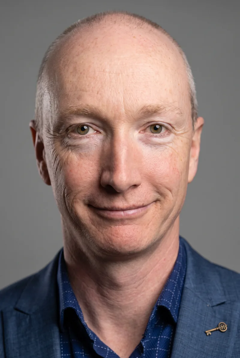 AI-generated portrait of Simon Harris, keynote speaker
